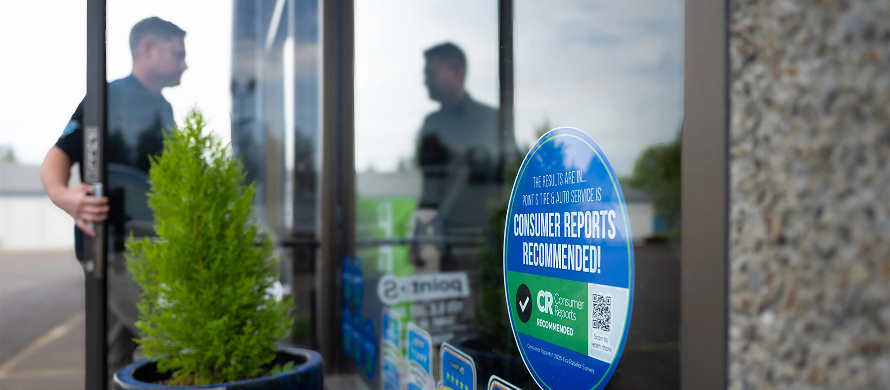A Consumer Reports Recommended decal on the front window of a Point S store