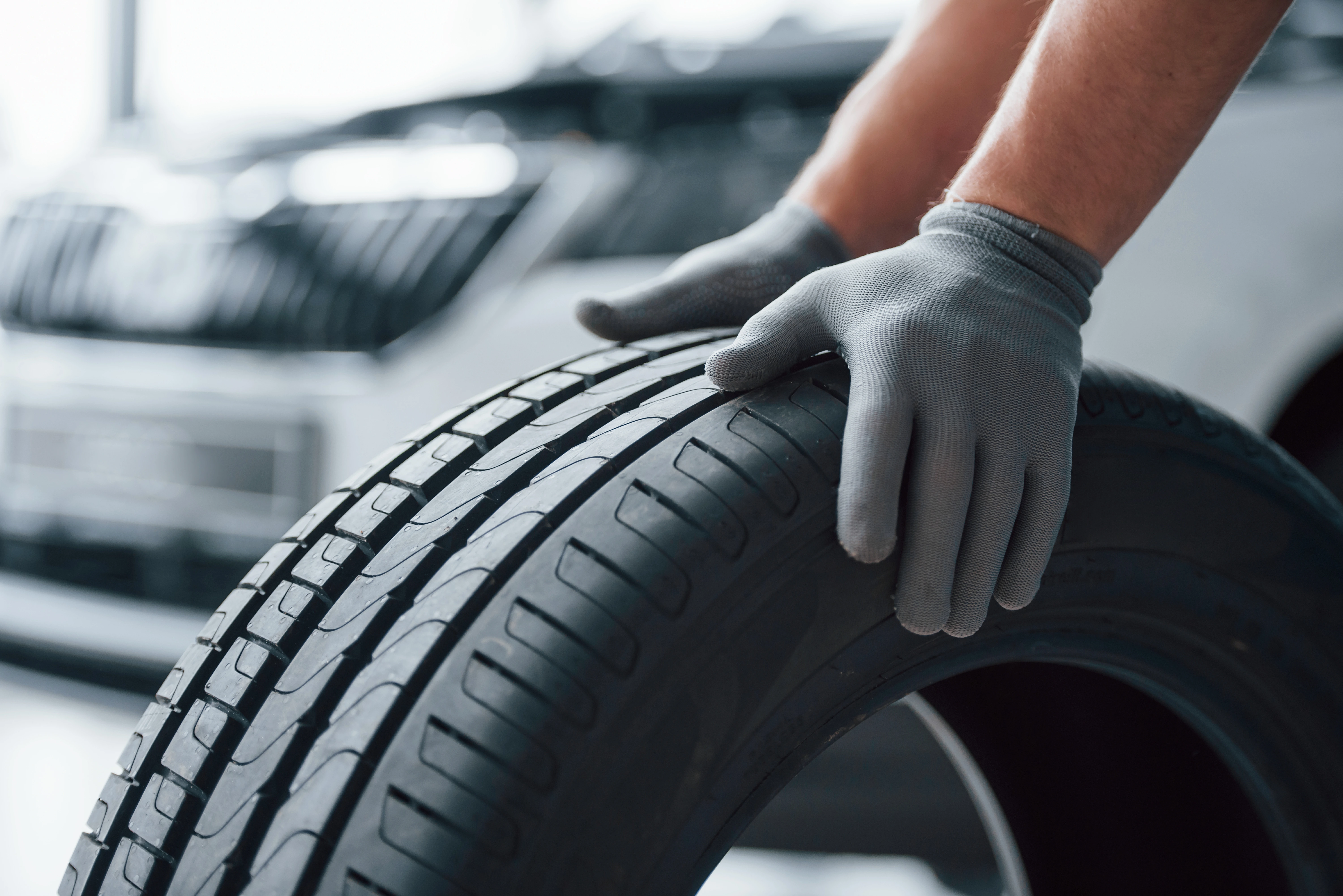 Technician handling a new tire